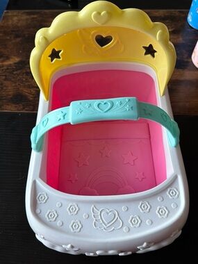 Disney pastel doll cradle in yellow, teal & pink